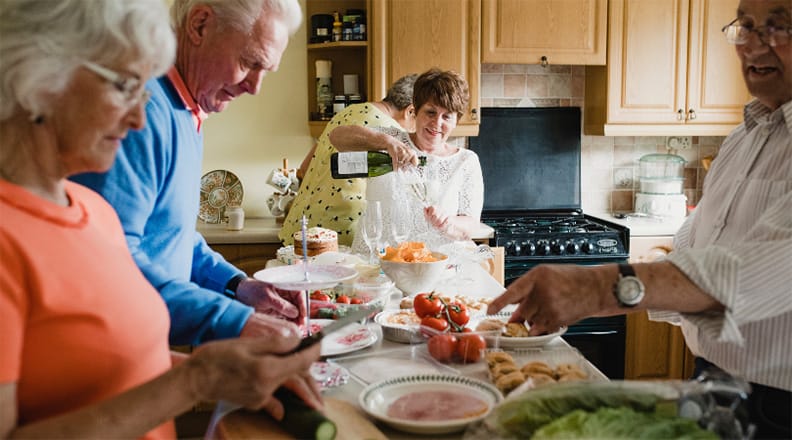 A family standing together in the kitchen